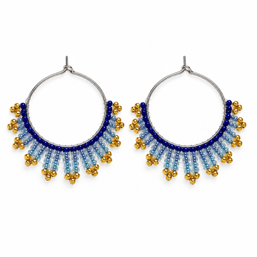 Pair of handmade beaded hoop earrings with royal blue, icy blue and gold seed beads on a white background